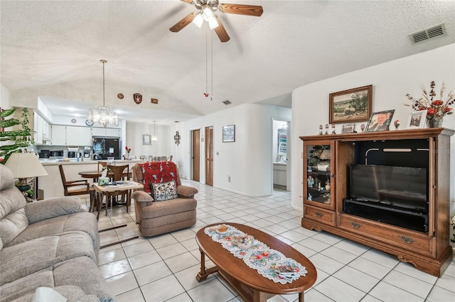 living room featuring lofted ceiling, ceiling fan with notable chandelier, a textured ceiling, and light tile patterned floors