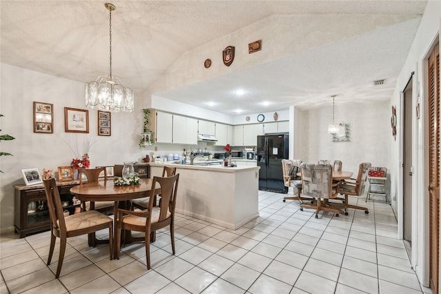 kitchen with white cabinetry, kitchen peninsula, black refrigerator with ice dispenser, and a notable chandelier