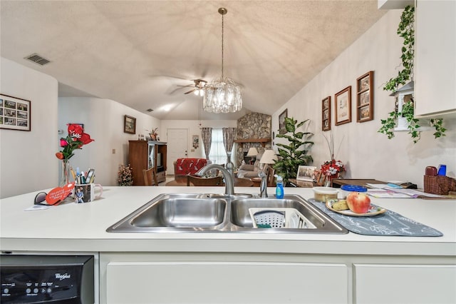 kitchen featuring sink, hanging light fixtures, a fireplace, vaulted ceiling, and a chandelier