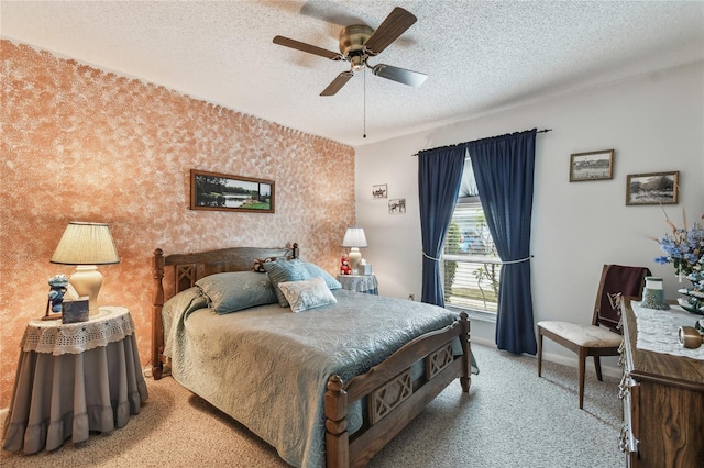 bedroom featuring ceiling fan, carpet flooring, and a textured ceiling