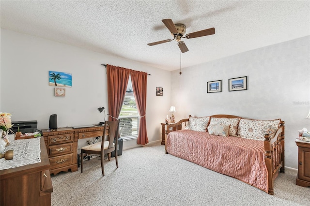 bedroom featuring ceiling fan, light colored carpet, and a textured ceiling