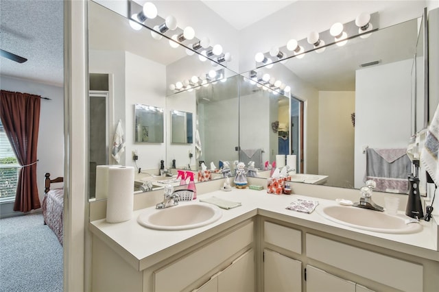 bathroom with a shower with door and vanity