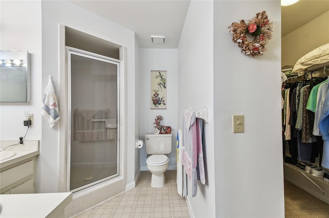 bathroom featuring walk in shower, vanity, and toilet