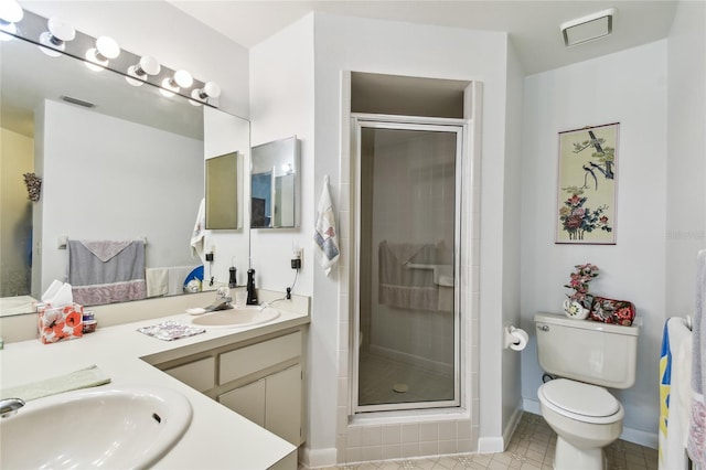 bathroom featuring vanity, an enclosed shower, and toilet