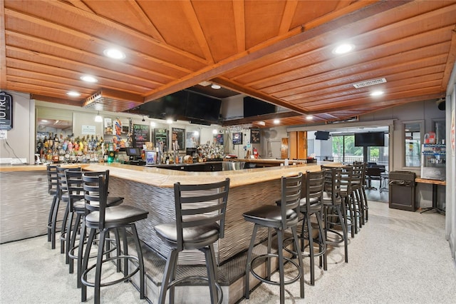 bar with wood ceiling and light carpet