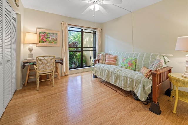 bedroom featuring ceiling fan, light hardwood / wood-style floors, and a closet