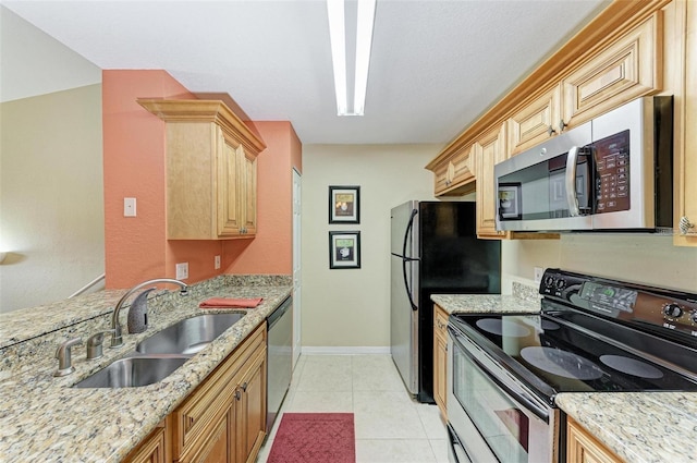 kitchen with sink, light brown cabinets, light tile patterned floors, stainless steel appliances, and light stone countertops