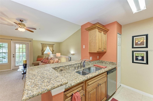 kitchen featuring lofted ceiling, sink, dishwasher, kitchen peninsula, and light stone countertops