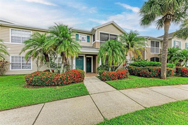 view of property featuring a front yard