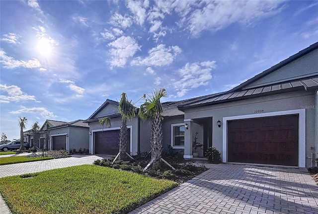 ranch-style home with a garage and a front lawn