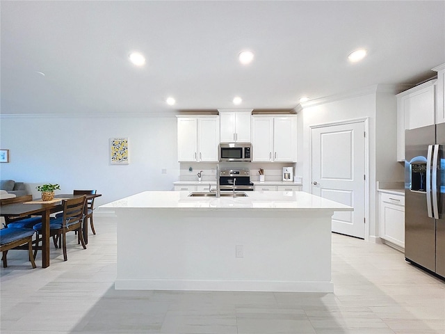 kitchen featuring white cabinetry, appliances with stainless steel finishes, and a kitchen island with sink