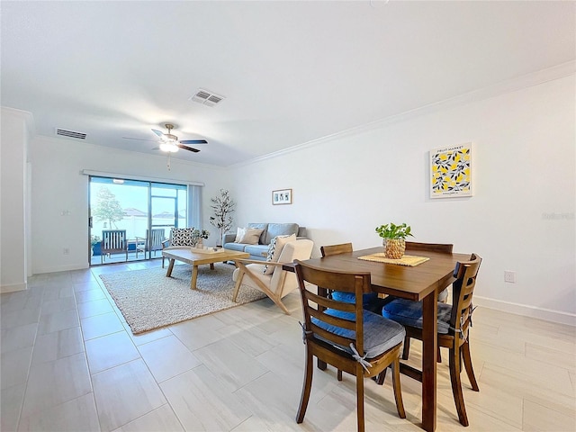 dining area featuring crown molding and ceiling fan