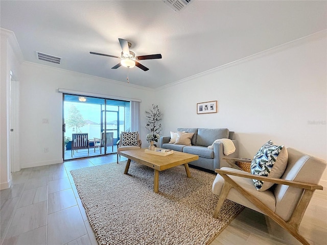 living room with ceiling fan and ornamental molding