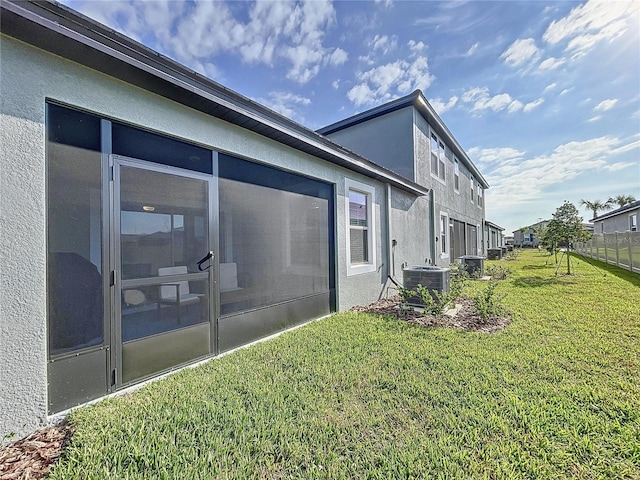 view of home's exterior featuring a yard and central air condition unit