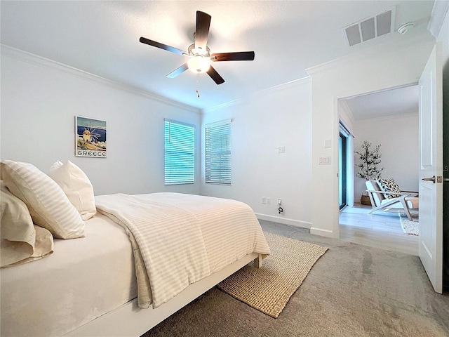 bedroom with crown molding, ceiling fan, and light carpet