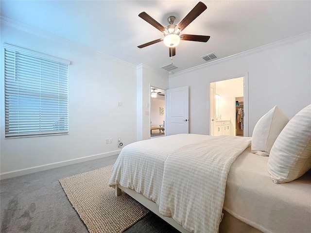 carpeted bedroom featuring crown molding, ceiling fan, and ensuite bath