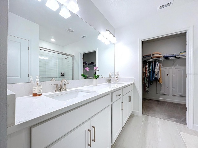 bathroom featuring vanity, tile patterned flooring, and a shower with door