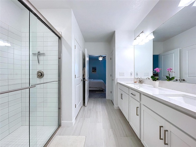 bathroom with vanity, ceiling fan, and walk in shower