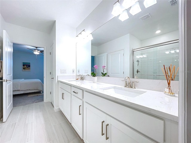 bathroom with vanity, ceiling fan, and a shower with shower door