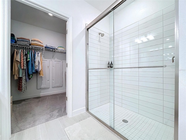 bathroom featuring tile patterned flooring and a shower with door