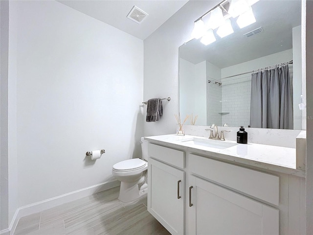 bathroom featuring vanity, toilet, and a shower with shower curtain