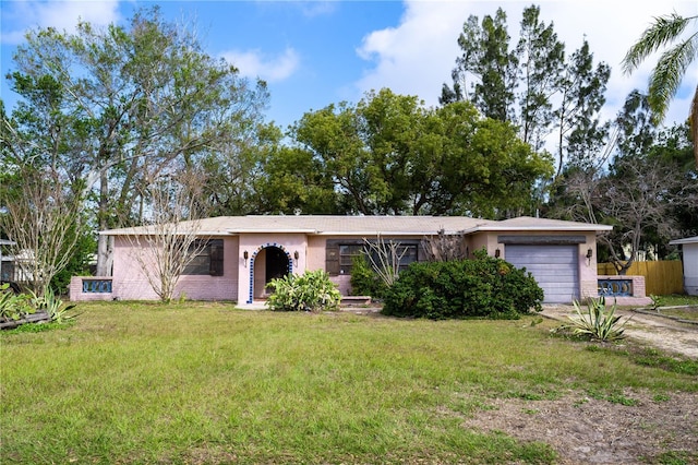 single story home with a garage and a front yard