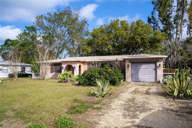 single story home with a garage and a front yard