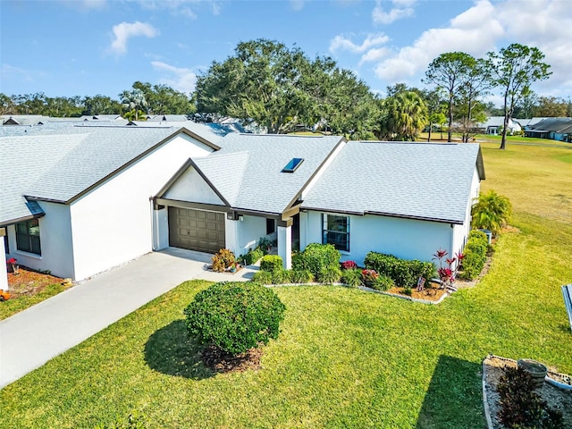 single story home featuring a garage and a front lawn