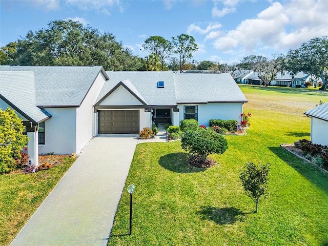 single story home featuring a garage and a front lawn