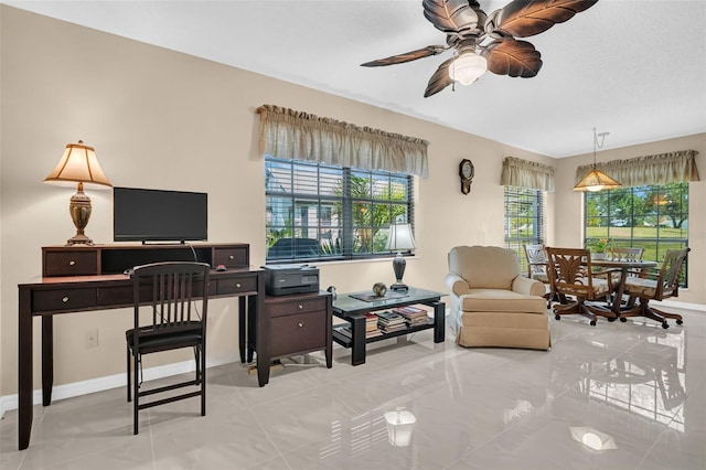 office area with light tile patterned floors and ceiling fan