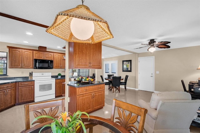 kitchen featuring light tile patterned floors, decorative light fixtures, white electric stove, and a center island