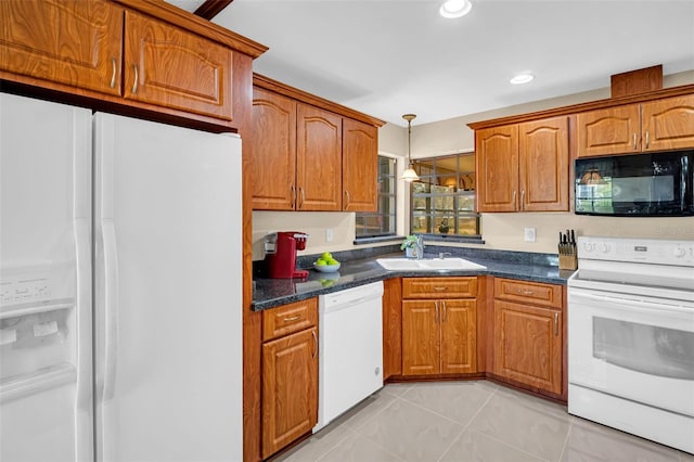 kitchen featuring sink, white appliances, and hanging light fixtures