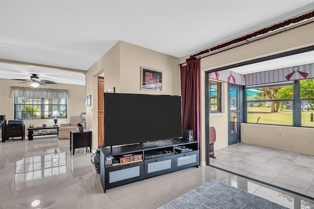 tiled living room featuring ceiling fan