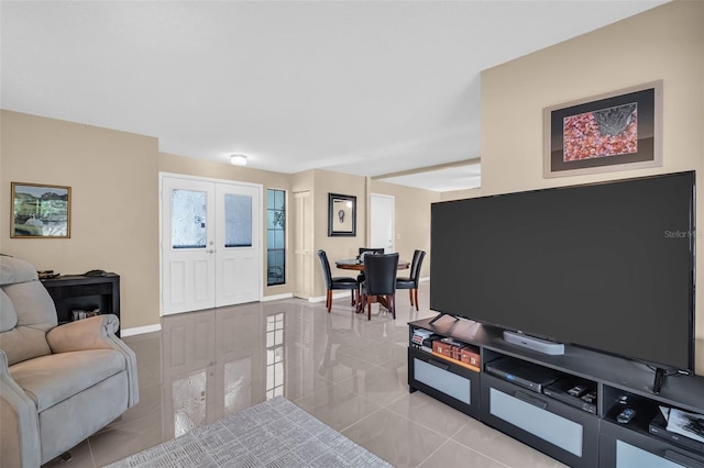 living room featuring light tile patterned flooring and french doors