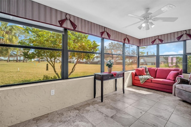 sunroom / solarium featuring ceiling fan