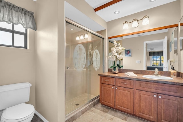 bathroom featuring vanity, toilet, and an enclosed shower