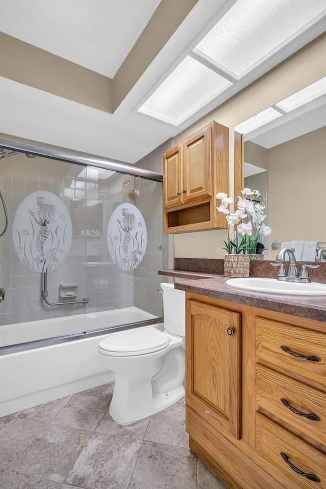 full bathroom with vanity, shower / bath combination with glass door, and toilet