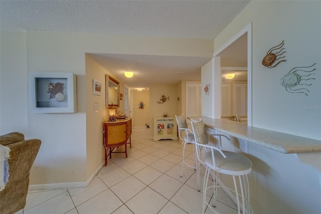 kitchen featuring light tile patterned floors and a textured ceiling