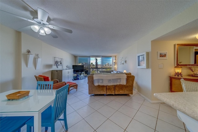 dining room with ceiling fan, a textured ceiling, and light tile patterned flooring