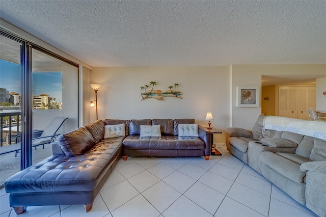 living room featuring light tile patterned floors, a wall of windows, and a textured ceiling