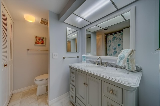 bathroom featuring vanity and toilet