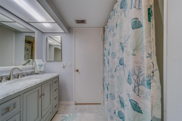 bathroom with vanity, curtained shower, and tile patterned flooring