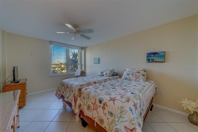 tiled bedroom featuring ceiling fan