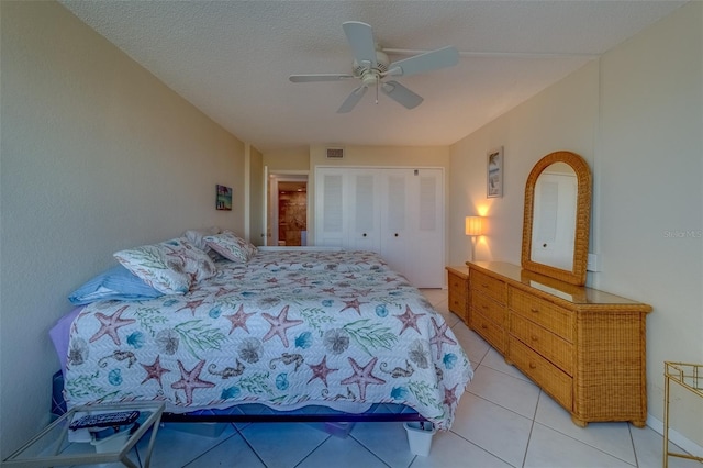 tiled bedroom featuring a textured ceiling, a closet, and ceiling fan