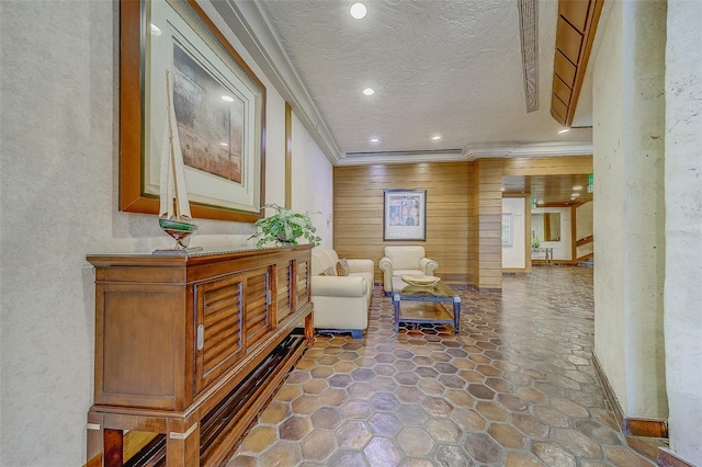 interior space featuring ornamental molding and a textured ceiling