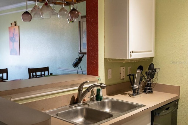 kitchen featuring white cabinetry, sink, pendant lighting, and black dishwasher