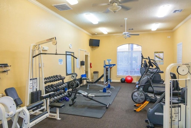 gym featuring a textured ceiling, ornamental molding, and ceiling fan