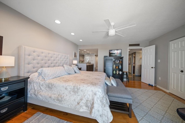 bedroom with hardwood / wood-style floors and ceiling fan