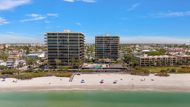 view of property featuring a water view and a beach view