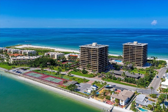 birds eye view of property with a beach view and a water view